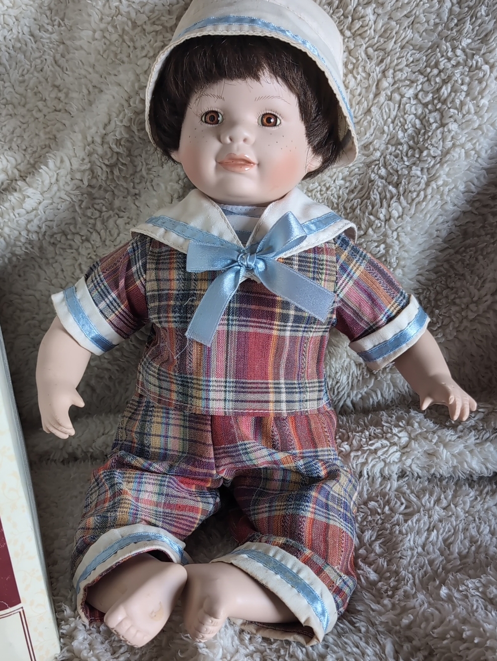 Porcelain Baby Doll in Multicolor Plaid Outfit with Light Blue Trim
